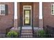 Charming front entrance with brickwork and black railing, creating a welcoming curb appeal at 2736 Bell Se Dr, Smyrna, GA 30080