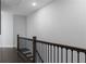 Upstairs hallway features dark wood floors, white walls, and black metal railing at 2736 Bell Se Dr, Smyrna, GA 30080