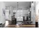 Contemporary kitchen boasts an island with barstool seating, stainless appliances, and dark hardwood floors at 2736 Bell Se Dr, Smyrna, GA 30080