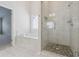 Bathroom featuring a soaking tub, frameless glass shower with stone floor, and white wall tile at 5340 Candun Cir, Sugar Hill, GA 30518