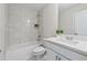 Modern bathroom boasts white subway tile, a shower-tub combination, and a sleek vanity with storage at 5340 Candun Cir, Sugar Hill, GA 30518