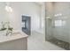 A spacious bathroom with a double sink vanity, a soaking tub, and a glass enclosed shower with stone floor at 5340 Candun Cir, Sugar Hill, GA 30518