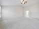 A spacious bedroom with neutral carpet and a ceiling fan at 5340 Candun Cir, Sugar Hill, GA 30518