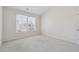 This bedroom features neutral walls, plush carpeting, and a large window for natural light at 5340 Candun Cir, Sugar Hill, GA 30518