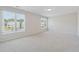 Bright bedroom features neutral walls, plush carpeting, and large windows for abundant natural light at 5340 Candun Cir, Sugar Hill, GA 30518