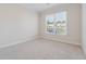 Bright bedroom featuring neutral walls, plush carpeting, and a large window for ample natural light at 5340 Candun Cir, Sugar Hill, GA 30518