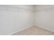 A walk-in closet with neutral carpet and wire shelving for clothes and storage at 5340 Candun Cir, Sugar Hill, GA 30518