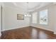 Dining room with hardwood floors, elegant lighting fixture, and large window at 5340 Candun Cir, Sugar Hill, GA 30518