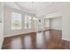 Elegant dining room with hardwood floors, stylish lighting, and a view through the windows at 5340 Candun Cir, Sugar Hill, GA 30518