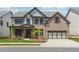 A beautiful two-story brick home with a well-manicured lawn and a two-car garage at 5340 Candun Cir, Sugar Hill, GA 30518