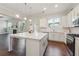 Kitchen island with white countertop and stainless steel appliances at 5340 Candun Cir, Sugar Hill, GA 30518