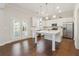 Bright kitchen featuring white cabinetry, a center island, and stainless steel appliances at 5340 Candun Cir, Sugar Hill, GA 30518