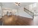 Open-concept living area with hardwood floors, a fireplace, and a seamless transition to the kitchen at 5340 Candun Cir, Sugar Hill, GA 30518