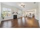 Spacious living room with hardwood floors, fireplace and an open floor plan to the kitchen at 5340 Candun Cir, Sugar Hill, GA 30518