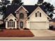 Charming two-story home featuring stone accents, a two-car garage, and a well-manicured front lawn at 2557 Casablanca Dr, Conyers, GA 30012