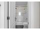 Bright bathroom featuring a white subway tile shower, gold fixtures, and a modern toilet at 3475 Oak Valley Ne Rd # 2820, Atlanta, GA 30326