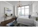 Inviting bedroom featuring a large window, cityscape views, and stylish decor with natural light at 3475 Oak Valley Ne Rd # 2820, Atlanta, GA 30326