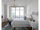 Serene bedroom featuring a large window, cityscape views, and stylish decor with natural light at 3475 Oak Valley Ne Rd # 2820, Atlanta, GA 30326