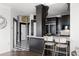 Kitchen featuring white marble island with seating, custom black cabinets and stainless steel appliances at 3475 Oak Valley Ne Rd # 2820, Atlanta, GA 30326