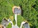An aerial view of a home with a well-manicured lawn, surrounded by lush greenery and mature trees at 3688 Eagles Beek Cir, Lithonia, GA 30038