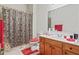 A bathroom featuring a single sink vanity, tile flooring, and a shower with patterned curtain at 3688 Eagles Beek Cir, Lithonia, GA 30038