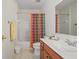 Cozy bathroom featuring a shower with a colorful curtain, tile flooring, and a wood vanity at 3688 Eagles Beek Cir, Lithonia, GA 30038