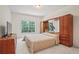 Bedroom with a large window overlooking the backyard and custom built-in storage at 3688 Eagles Beek Cir, Lithonia, GA 30038