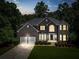Charming brick home with a two-car garage, manicured landscaping, and a welcoming front entrance at 3688 Eagles Beek Cir, Lithonia, GA 30038