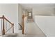 Hallway with carpet, wood railing and staircase at 3688 Eagles Beek Cir, Lithonia, GA 30038