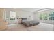 Bedroom featuring trey ceilings, neutral walls, bedside tables, and large windows at 3688 Eagles Beek Cir, Lithonia, GA 30038