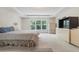 A bedroom offering large windows with a view of the backyard, neutral walls, and built-in shelving at 3688 Eagles Beek Cir, Lithonia, GA 30038