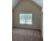 Bedroom with large window with blinds and neutral walls and carpeted floor at 1857 Kingsmere Run Dr, Loganville, GA 30052
