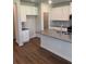 Modern kitchen island featuring granite countertops, white cabinets, stainless steel appliances and hardwood floors at 1857 Kingsmere Run Dr, Loganville, GA 30052