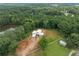 Stunning aerial showcases the home's architectural uniqueness nestled within a serene environment, complemented by lush landscaping at 5210 Brownlee Rd, Stone Mountain, GA 30087