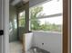 Bathroom under construction with waterproofed walls and a large window providing natural light and outdoor views at 5210 Brownlee Rd, Stone Mountain, GA 30087
