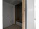 Bathroom alcove featuring a tiled shower/tub and awaiting final fixtures, showcasing the home's potential at 5210 Brownlee Rd, Stone Mountain, GA 30087