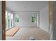 Large bedroom under construction featuring multiple windows, providing ample natural light and views of the surrounding landscape at 5210 Brownlee Rd, Stone Mountain, GA 30087