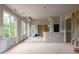 Expansive living room under construction, with large windows offering ample natural light and scenic outdoor views at 5210 Brownlee Rd, Stone Mountain, GA 30087