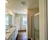 Bathroom featuring a double vanity, a glass shower, and a soaking tub at 1909 Victoria Way # 116, Conyers, GA 30013