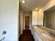 Bathroom featuring a double vanity with granite counters and a glass-enclosed shower at 1909 Victoria Way # 116, Conyers, GA 30013