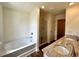 Bathroom with soaking tub, glass shower, and double sink vanity with granite counters at 1909 Victoria Way # 116, Conyers, GA 30013