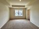 Primary bedroom featuring trey ceiling and plush carpet at 1909 Victoria Way # 116, Conyers, GA 30013