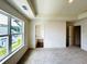 Bright bedroom featuring large windows and neutral carpet, adjacent to the ensuite bathroom at 1909 Victoria Way # 116, Conyers, GA 30013
