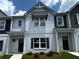 New two-story townhome with white brick, dark shutters, and craftsman-style details at 1909 Victoria Way # 116, Conyers, GA 30013