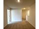 Carpeted upstairs hallway with neutral paint and lighting at 1909 Victoria Way # 116, Conyers, GA 30013