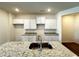 Modern kitchen with stainless steel sink and granite countertops at 1909 Victoria Way # 116, Conyers, GA 30013