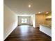 Open-concept living area with hardwood floors and abundant natural light at 1909 Victoria Way # 116, Conyers, GA 30013