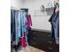Organized walk-in closet featuring dark dresser with shelving and plenty of hanging storage at 1190 Buice Lake Pkwy, Acworth, GA 30102