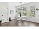 Bright dining area featuring modern lighting, hardwood floors, and a glass table with seating at 1190 Buice Lake Pkwy, Acworth, GA 30102