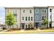Modern townhome features colorful siding, manicured landscaping, and inviting entrances at 1190 Buice Lake Pkwy, Acworth, GA 30102